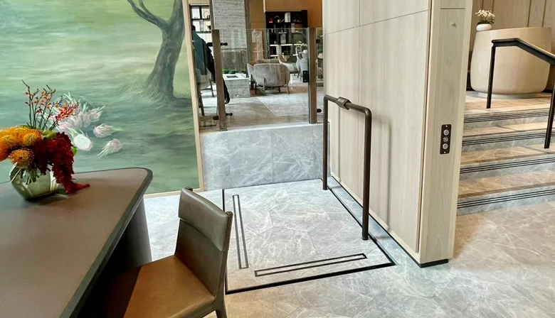 Luxury Lyfthaus platform lift with marble floor, elegant wood panelling, and simple controls.